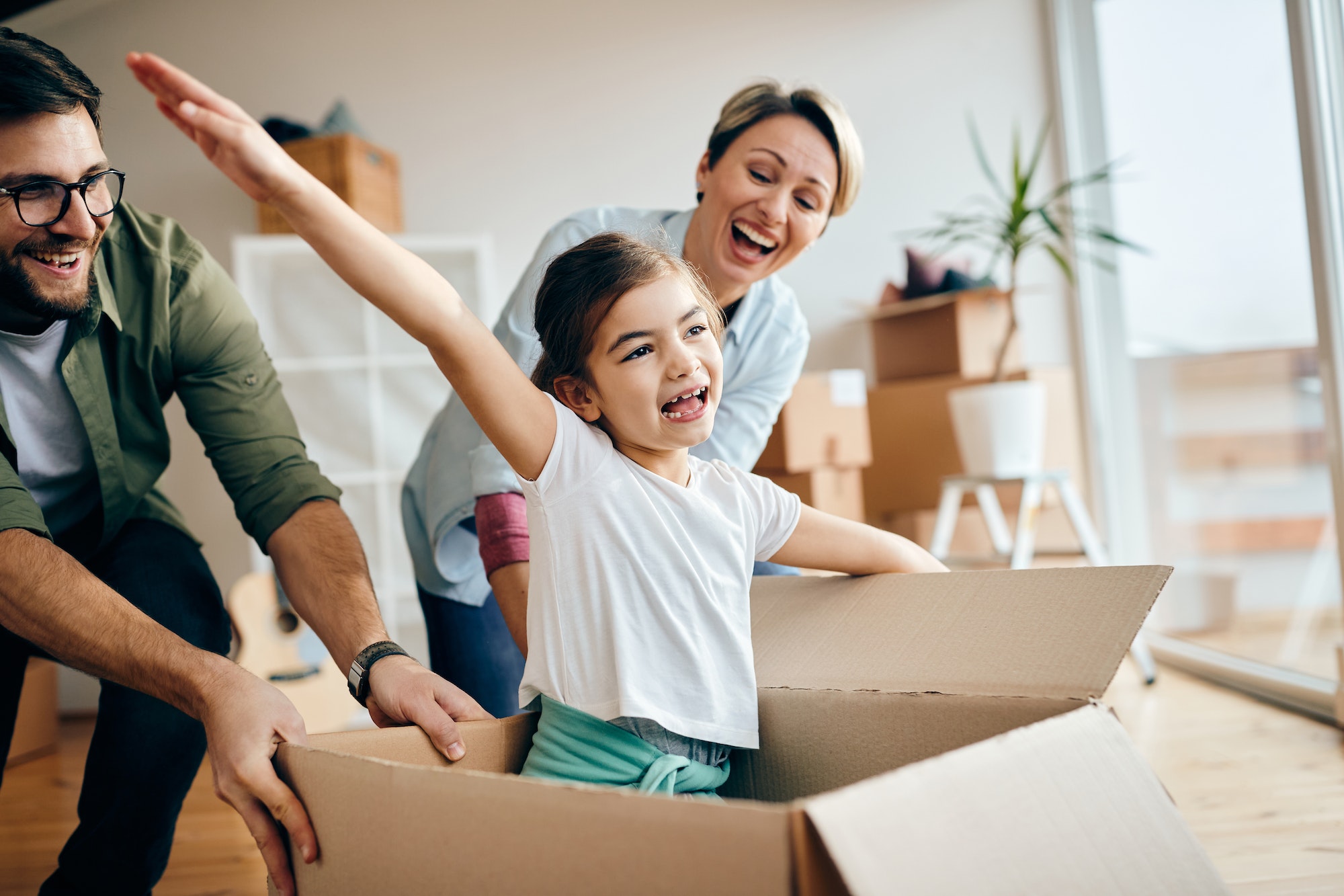 Cheerful family having fun while moving into their new home.